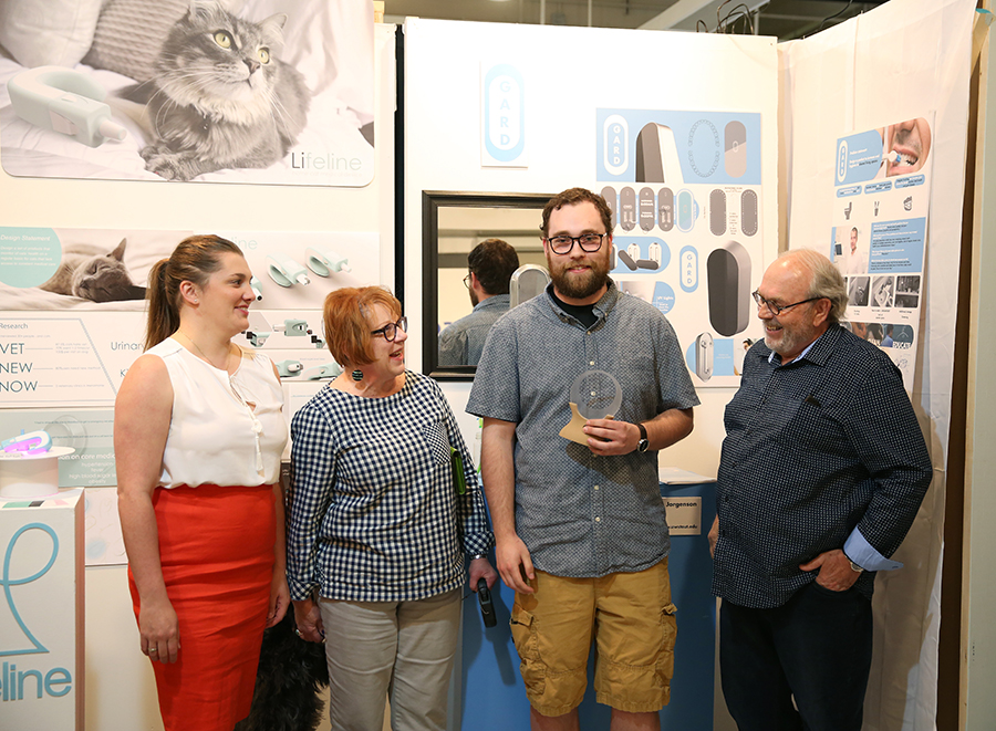 Blake Shermer accepts the first Noah Norton Portfolio Prize Endowed Fund at the Senior Show in early May. Also pictures is Dana Cowan, Norton’s wife, and his parents Denis and Sara Norton.