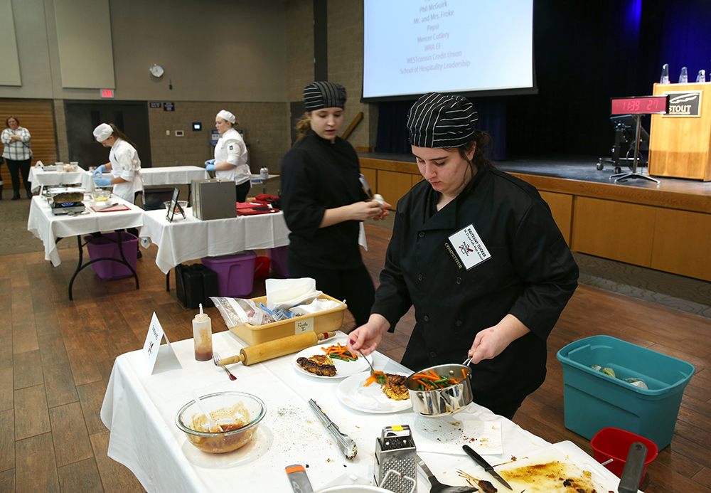 St. Croix Falls High School students Isabelle Coen, at left, and Brittany Tucker took second place in the culinary competition at UW-Stout. UW-Stout photo by Brett Roseman.