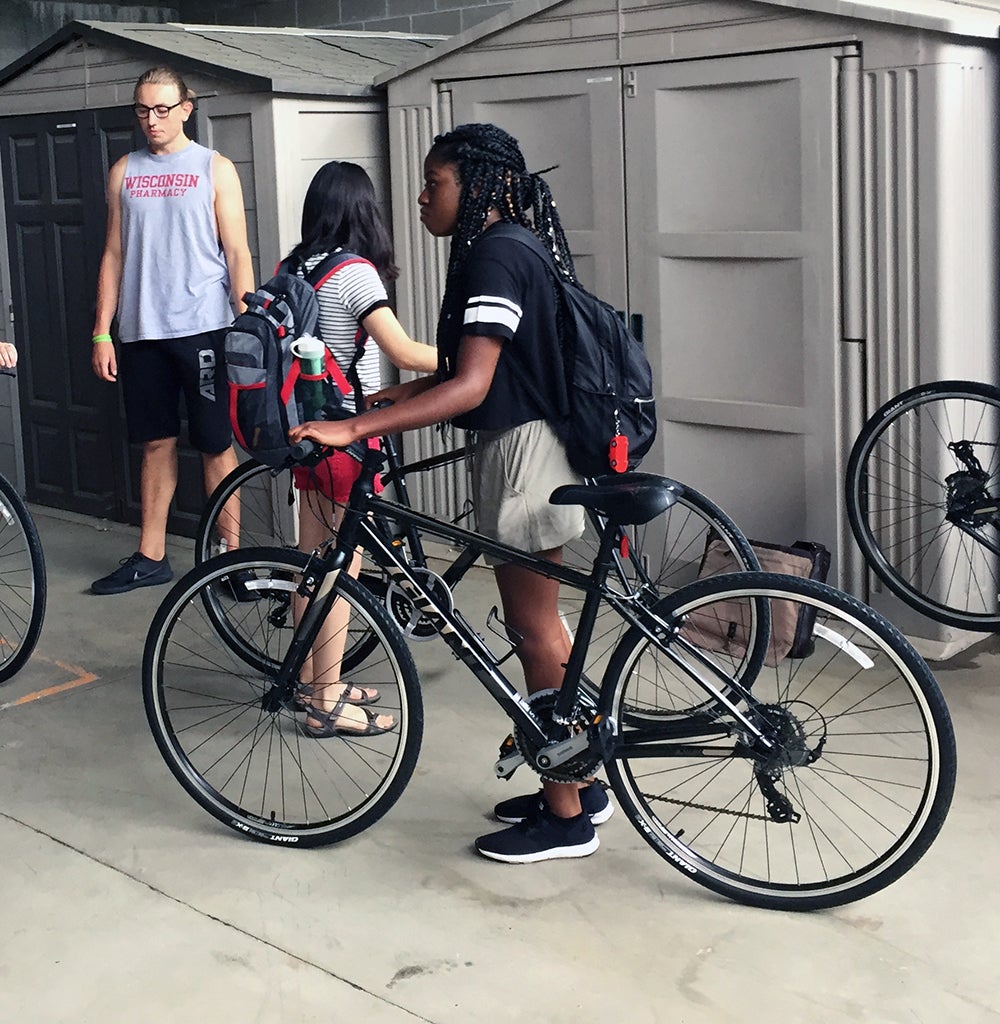 LAKES REU student Zayyan Swaby, of Stony Brook University, New York, checks out the fit of a bicycle from StoutBikes 