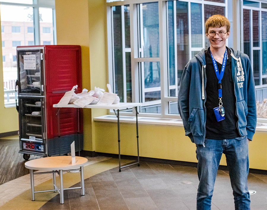 Student Nate Geschwill with some meals delivered to residence halls.