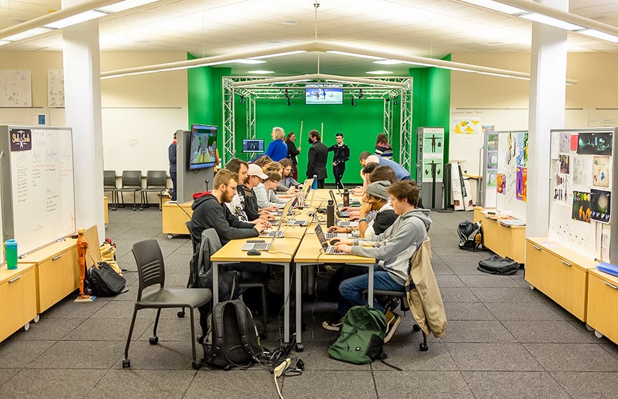 Stout students use the conferencing table in the lab space