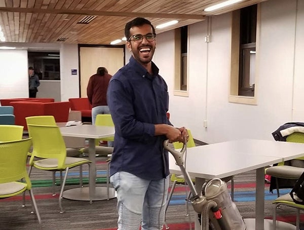 Sulaiman Alharbi, from Saudi Arabia, vacuums in a community room at a UW-Stout residence hall.