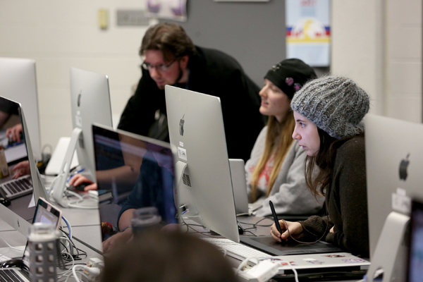 Instructor Jesse Woodward helps students in his Animation Studio class.