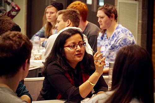 Professor Lopa Basu works with students.