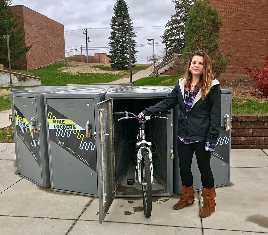 Student Meta Adams uses one of the new campus bike lockers.