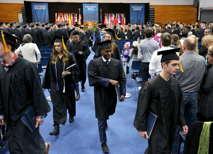 Graduates, with diplomas in hand, exit Johnson Fieldhouse after the Saturday morning ceremony. 
