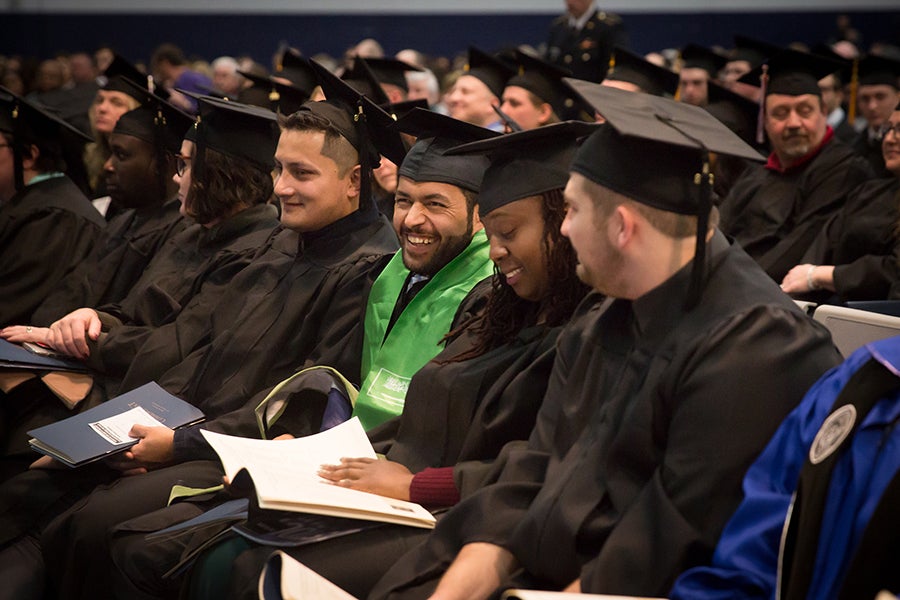 Students enjoy a laugh during one of Saturday’s commencement ceremonies.