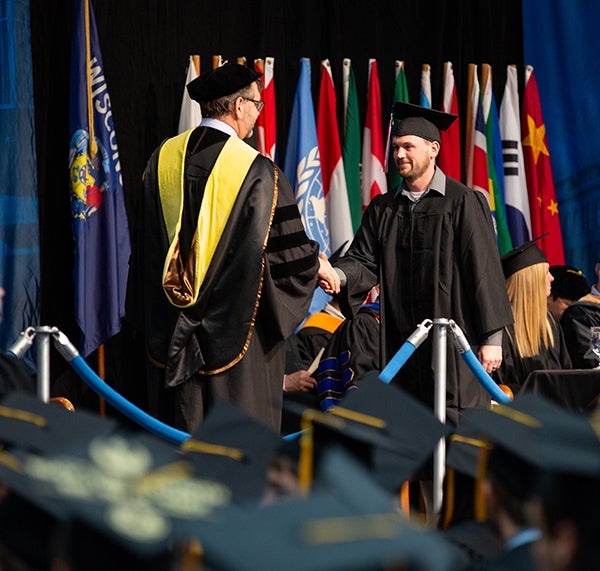 Brent Coulthart receives his diploma Saturday, May 4, at Johnson Fieldhouse.