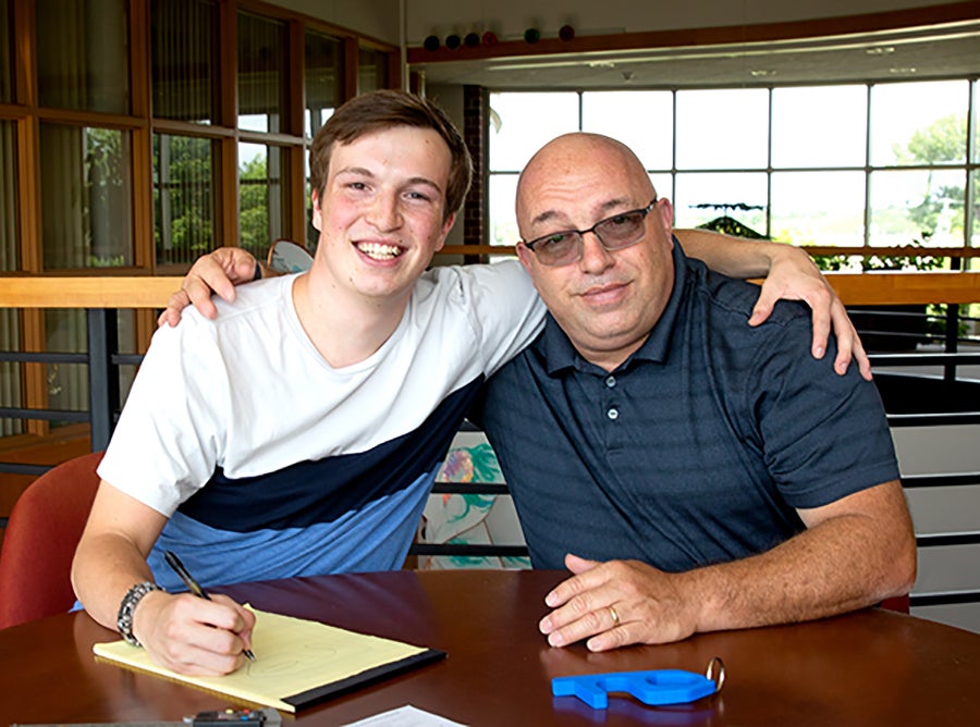 Jake Thomas’ original door puller, on table, was designed and 3D-printed after a request from his father, John, right.