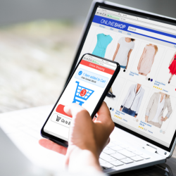 A phone with the shopping chart icon and a background of a onlineshop selling clothes