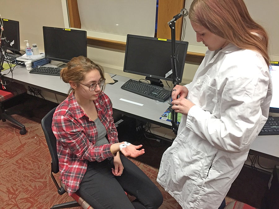 Ja Doul hooks up electrodes to Hera’s hand to ready for a test.