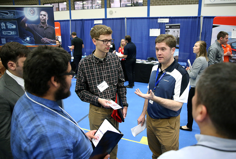 Foxconn recruiter Robert Schlaeger, right, talks with students.