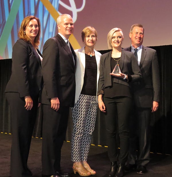 UW-Stout’s Emily Gross, second from right, receives her Source Award along with Associate Professor Julie Peterson, center, in San Diego. 