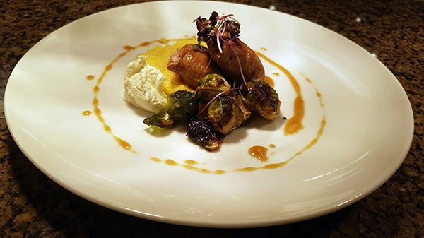 An entrée at Triple Creek Ranch prepared by Halverson includes seared quail breast with polenta, ricotta, roasted Brussels sprouts and herb jus.