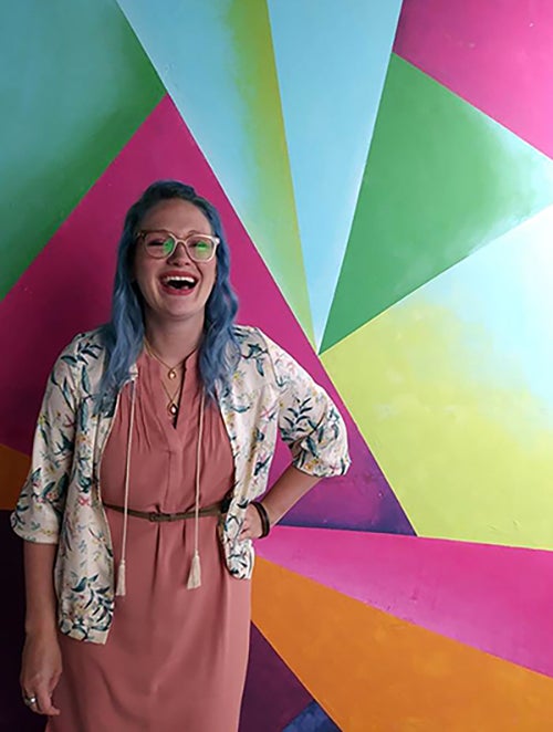 Emma Harris stops at a colorful backdrop in a photo studio at Kohl’s corporate, where she interned last summer and where she’ll work full time starting in February.