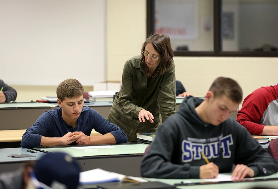 Monika Herrmann, one of the book authors, works with students in her Engineering Graphics Fundamentals class.