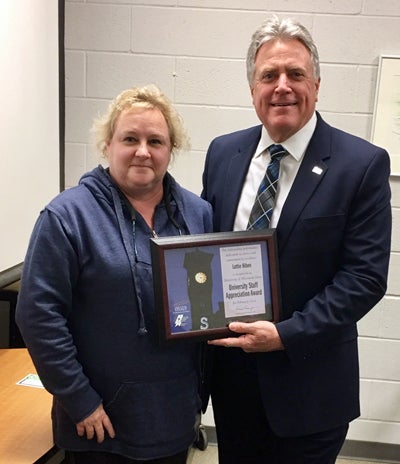 Lottie Hiben receives the University Staff Employee Appreciation Award for February from Chancellor Bob Meyer.