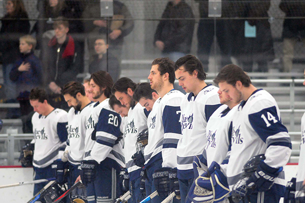 Members of UW-Stout’s hockey team line up during the national anthem before a recent game against Hamline.