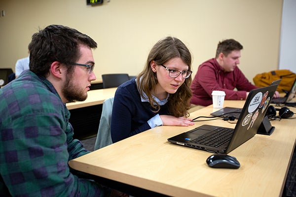 From left, Calvin Bunge, Larissa Ford and Ryan Vanden Boomen work on case studies in their Industrial Math class at UW-Stout.