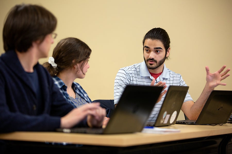 From left, students d’Artagnan Kramer, Natalie Bruns and David Amirahmadi discuss an issue in the class.