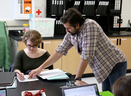 Assistant Professor Keith Gilland, right, instructs Anna Cramer, a sophomore from Pine Island, Minn., in the Science, the Environment and Sustainability biology class that helped remove invasive species from Menomonie’s Lakeside Park.