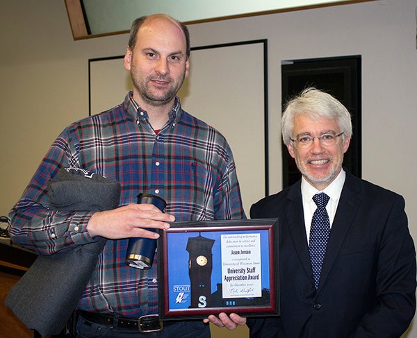 Jason Jenson, left, received the University Staff Employee Appreciation Award for December at UW-Stout from interim Chancellor Patrick Guilfoile.