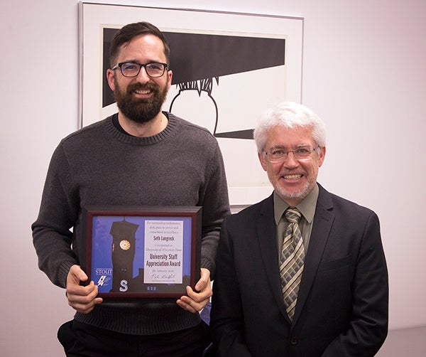 Seth Langreck, left, received the University Staff Employee Appreciation Award for January at UW-Stout from interim Chancellor Patrick Guilfoile.