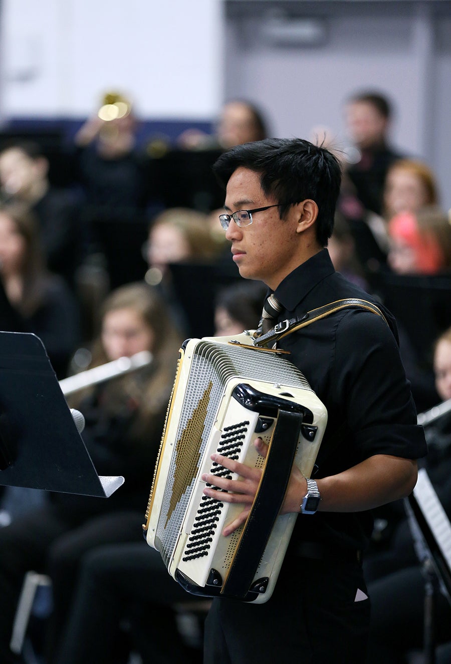 William Le plays the accordion at a recent concert.