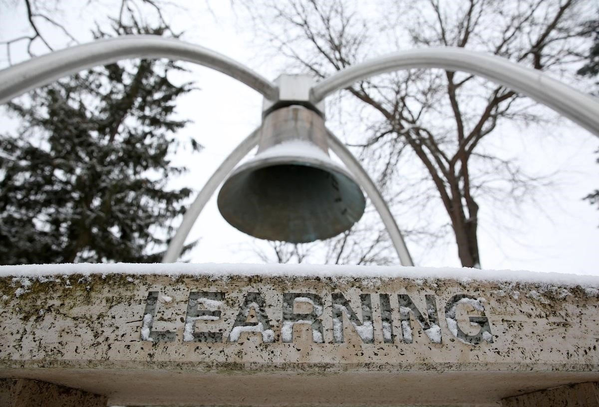 Image of a bell hanging above a sign that reads Learning 