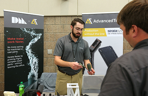 A manufacturing representative explains a product to an attendee at UW-Stout’s 2017 Manufacturing Advantage Conference and Tech Showcase.