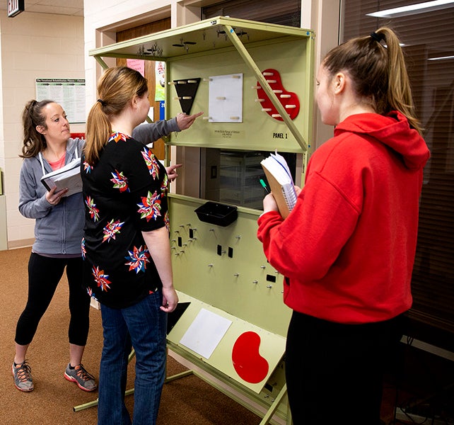 UW-Stout graduate students Taylor Michels, at left, Nicole Rued and Samantha Albert in a rehabilitation and counseling assessment and planning class taught by Professor Debra Homa engage in simulations of work-related tasks.