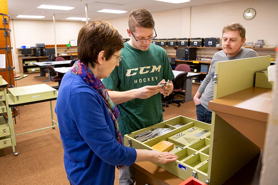 Professor Debra Homa, with graduate students Travis Mashuga and Josh Nielsen discuss a project as part of the rehabilitation and counseling assessment and planning class.