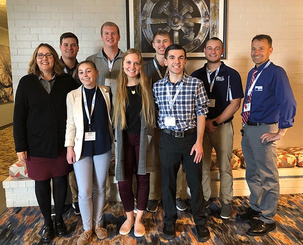 UW-Stout professors Debbie Stanislawski, left, and Urs Haltinner, right, attended a joint statewide business and marketing education conference with seven students. The students, from left, are Tanner Christopherson, Allison Rigotti, Ben Schwartz, Megan Weseli, Oliver Schroedl, Gavin Raph and Timothy Bott.
