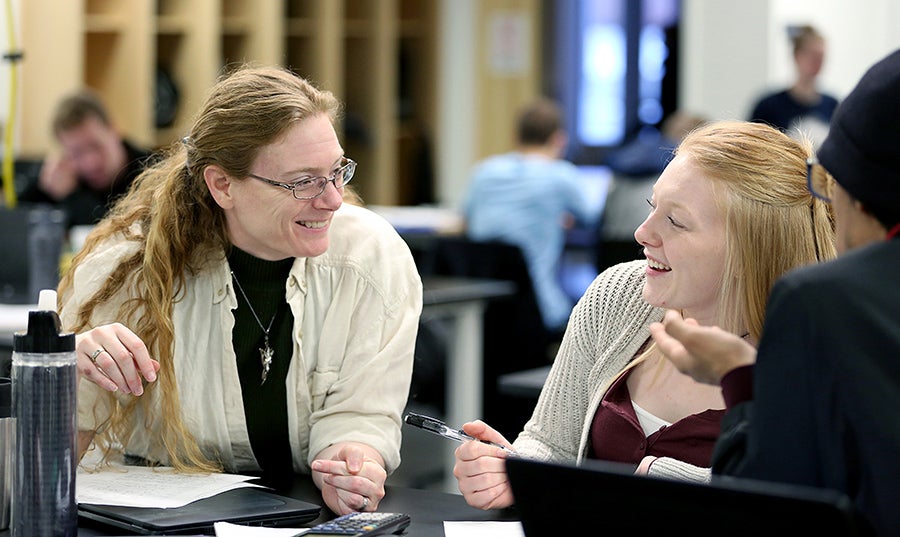 Professor Laura McCullough works with a student at UW-Stout.