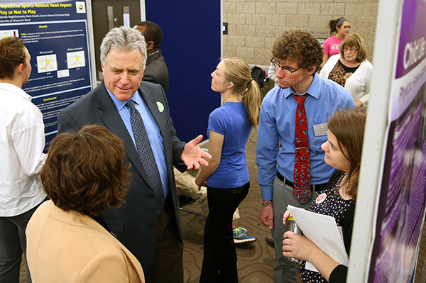 Meyer talks with students at Research Day presentations in 2015 at the Memorial Student Center.