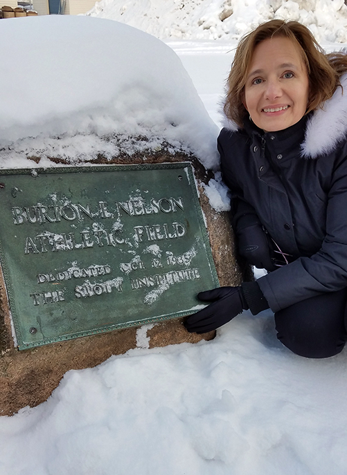 Nelson Field at UW-Stout was named after Burton Nelson when it was dedicated in 1935, while he still was president. His great-granddaughter, Stephanie Nelson Perry, pushed away snow to see the dedication plaque during a recent visit to campus.