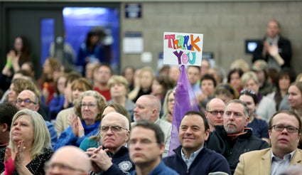 Employee Tom Dye holds a sign during a program at the Memorial Student Center to kick off the spring semester.