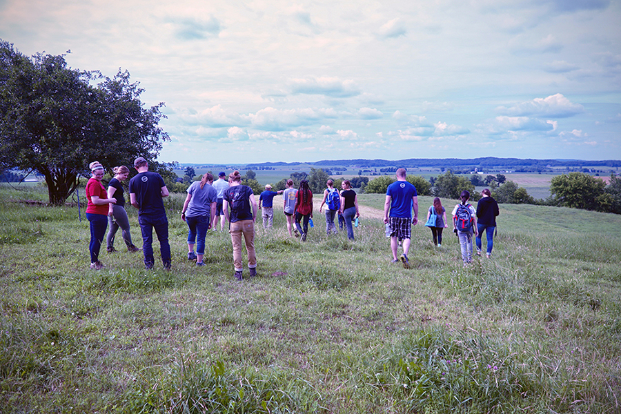 Students walk in a pasture in Dunn County to learn more about the soils and farming in the area. The LAKES REU students will share their summer research on Wednesday, Aug. 8, in Menomonie and Friday, Aug. 10, in Chetek.