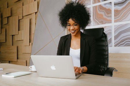 lady sitting at a desk watching laptop