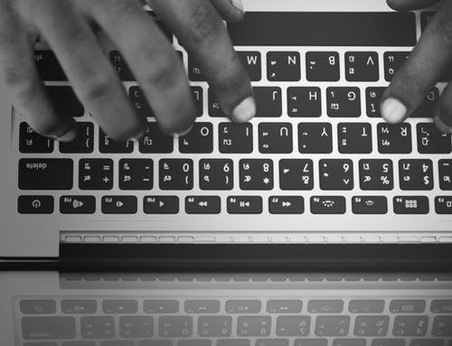 Hands typing on a keyboard
