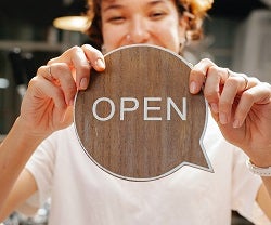 Happy women showing open sign 