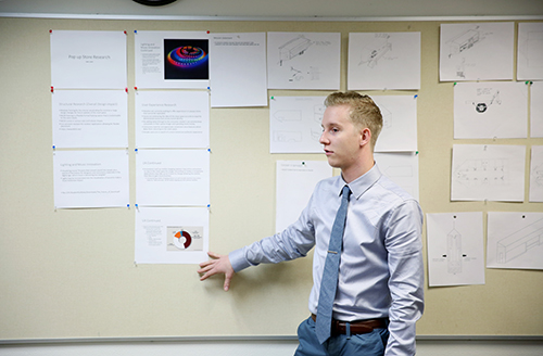 Jake Jubie, a UW-Stout retail management senior, explains ideas to attract consumers to the pop-up arcade store.