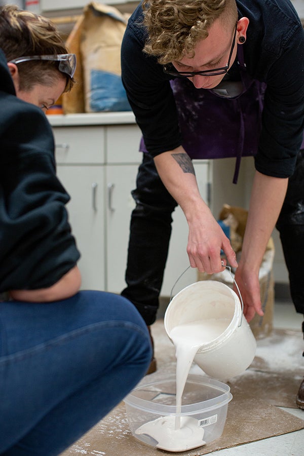 Alexandre Marble pours the porcelain for the Made at UW-Stout mugs.