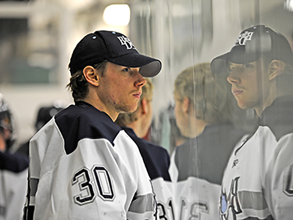 Etienne Roy watches from the sidelines at a UW-Stout hockey game.