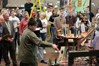 Rube Goldberg contest judges, including UW-Stout Chancellor Bob Meyer, second from left, watch a student describe the Spooner High School entry.