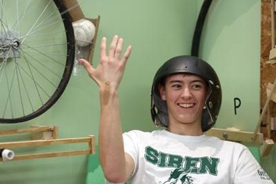 A Siren High School student shows a bandage on his arm after his team’s Rube Goldberg machine finished a run Monday.