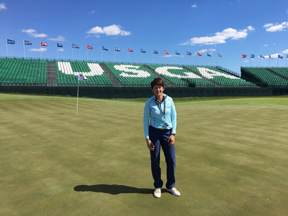 Kris Schoonover stands on the 18th green prior to the U.S. Open at Erin Hills. Schoonover is an assistant professor at UW-Stout and works in golf operations at Erin Hills.