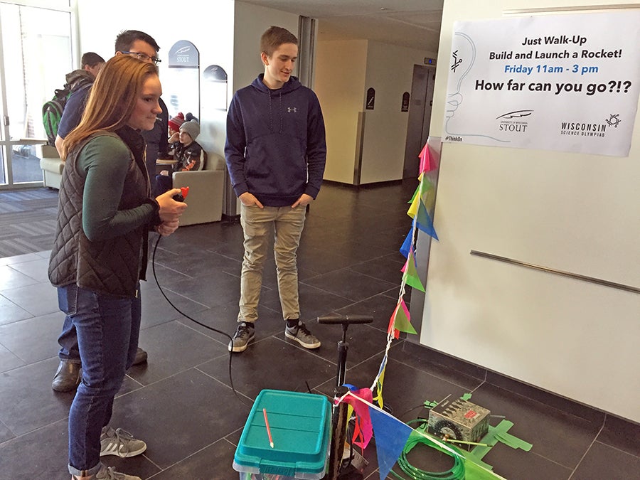 New Richmond High School students Katey Eickhoff, at left, and Merrick Scholz get ready to launch a drinking straw rocket the Stout Expo.