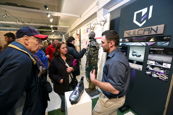 Visitors hear about a student’s shoe design at a 2017 Senior Show.