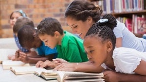 children reading with teacher